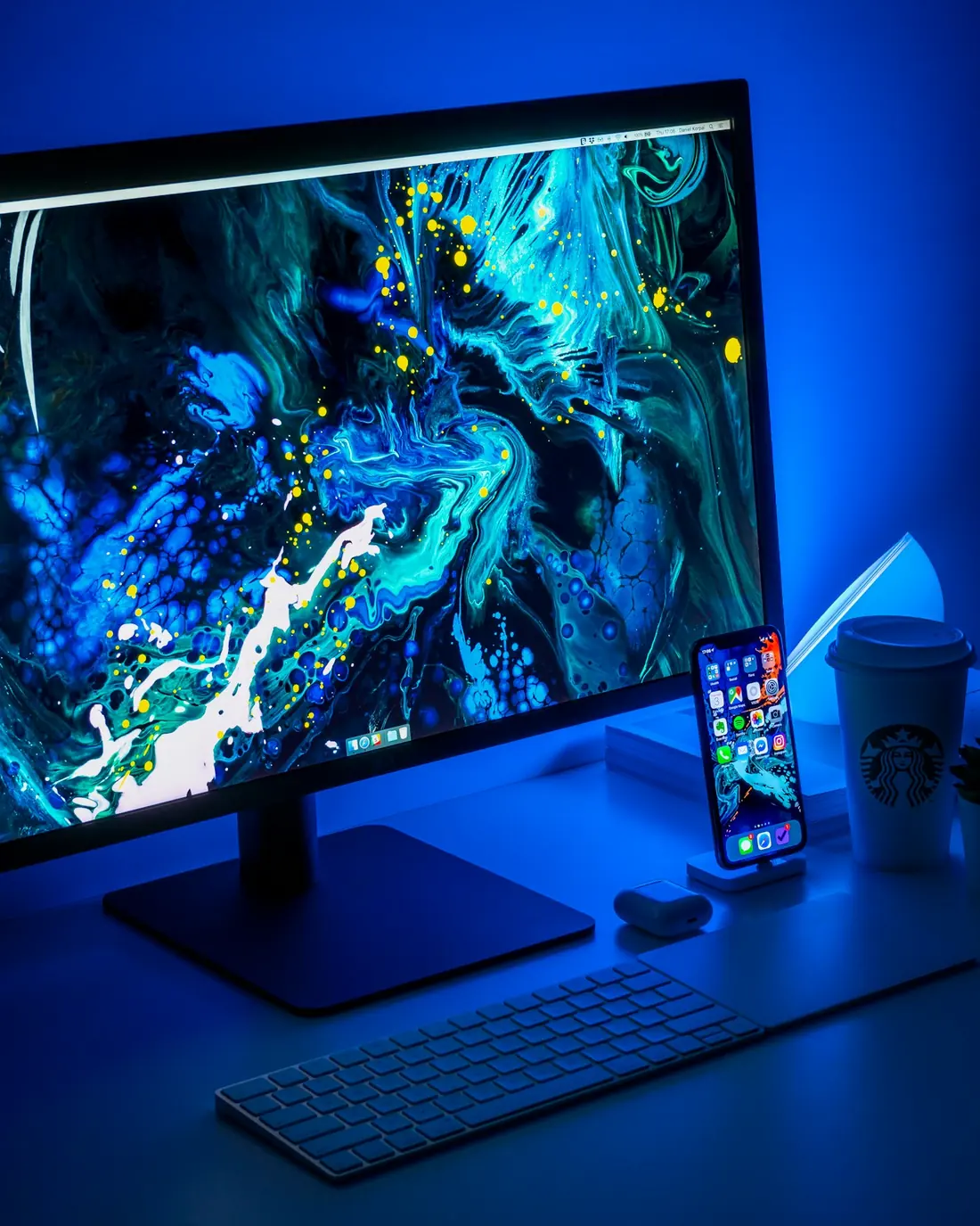 A monitor glowing blue on a desk