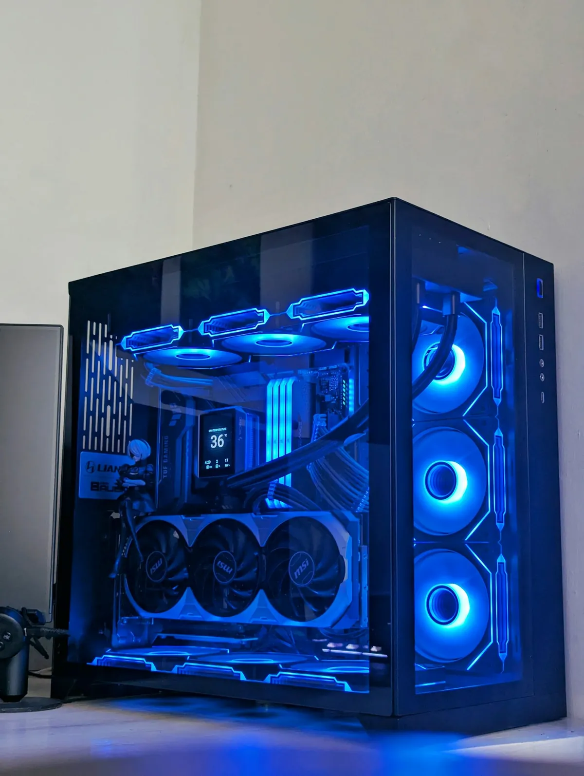 A custom-built PC in a glass case with blue-lit fans