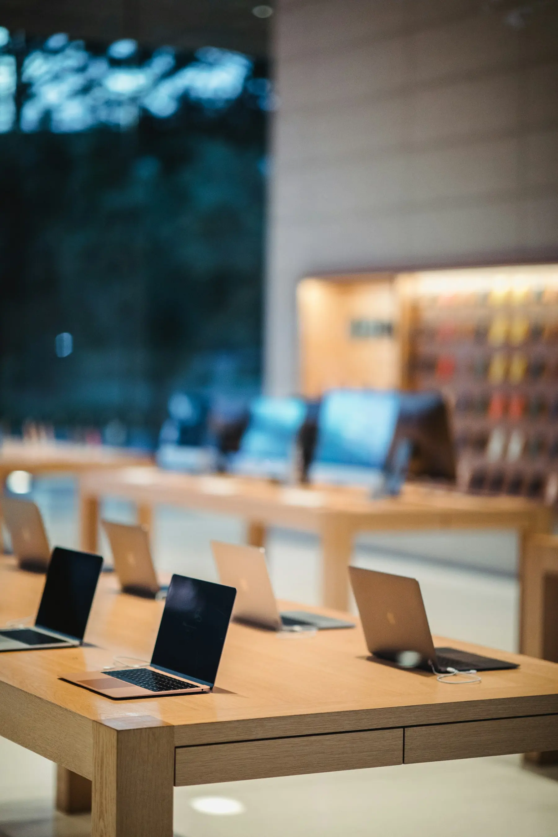 Laptops on display tables in a computer showroom